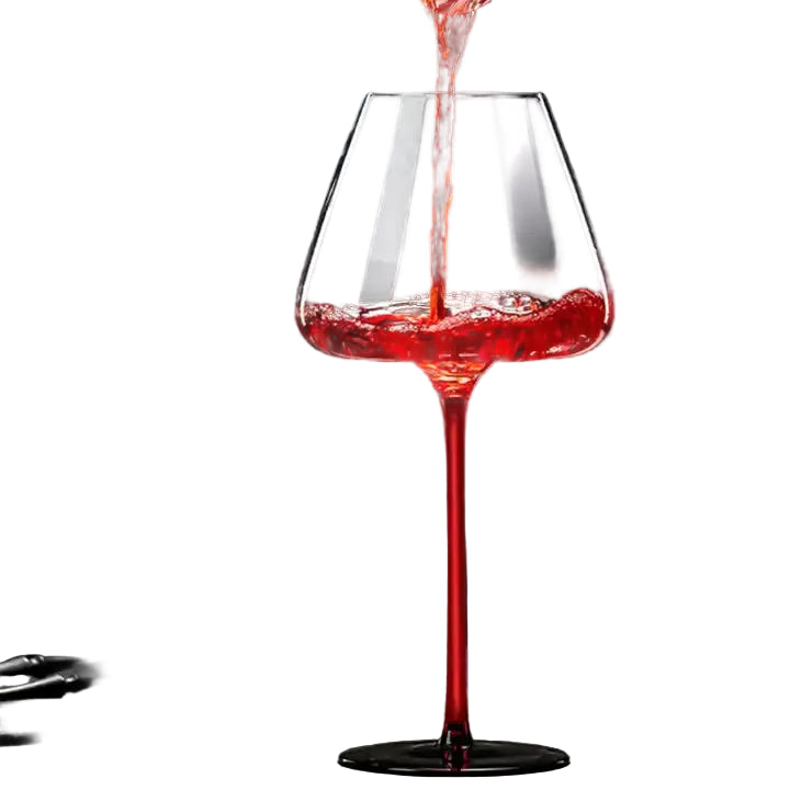 Red wine being poured into a glass with a dark background